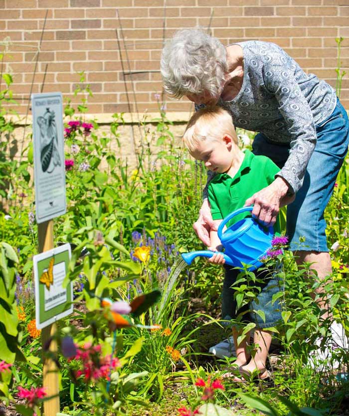 childcare-boy-minneapolis-senior-watering-plants-m